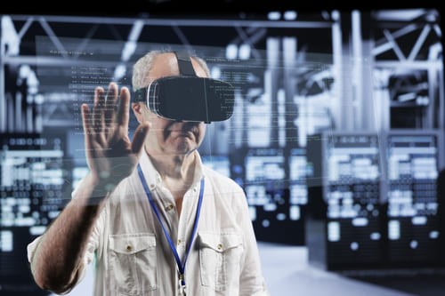 Manager using a virtual reality headset to interact with a data center