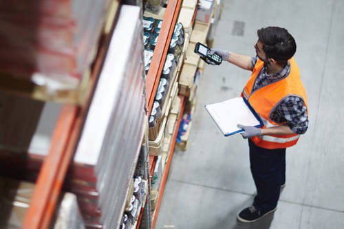 Warehouse worker scanning barcodes on products