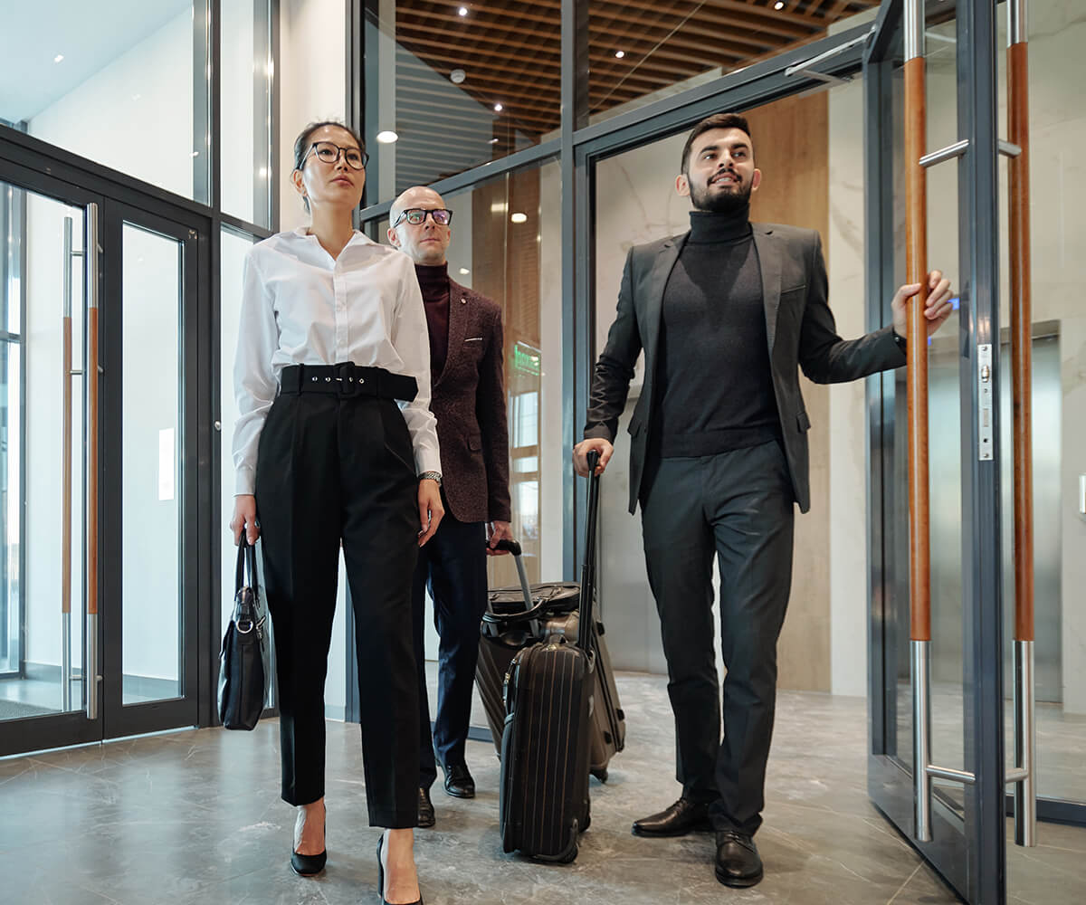 Group of People Walking Into Modern Room